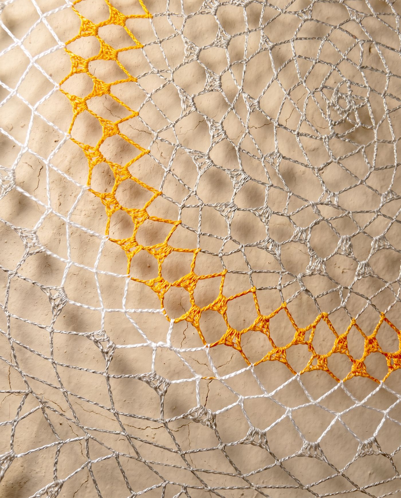 Close macro study of the woven thread pattern forming Silent Flight's concentric design.